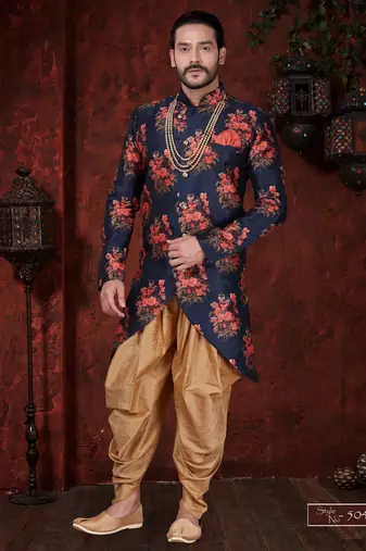 Navy blue floral sherwani with asymmetrical hem, pearl necklace, and gold trousers.