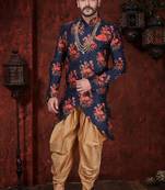 Navy blue floral sherwani with asymmetrical hem, pearl necklace, and gold trousers.
