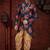 Navy blue floral sherwani with asymmetrical hem, pearl necklace, and gold trousers.