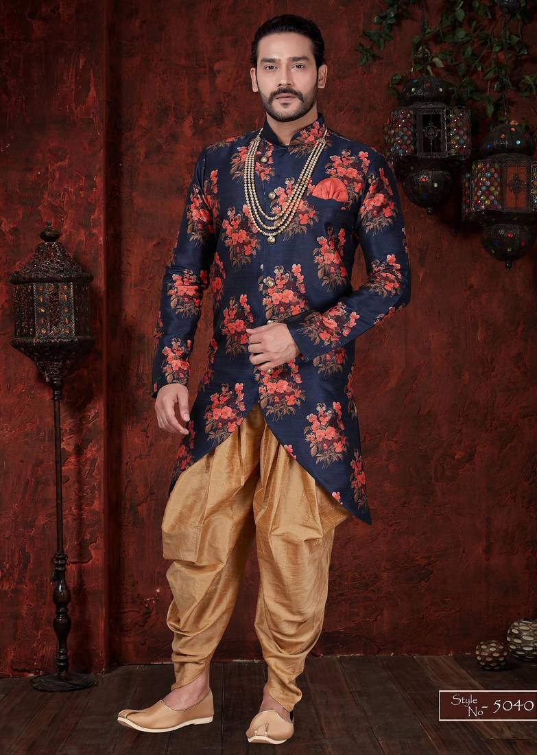 Navy blue floral sherwani with asymmetrical hem, pearl necklace, and gold trousers.