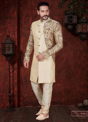 Fawn sherwani with floral sleeves, gold buttons, and matching trousers—ideal for weddings. 1