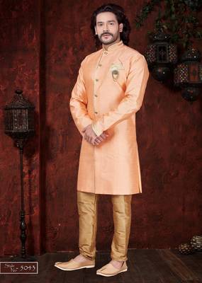 Peach sherwani with gold trim, ornate buttons, and matching pocket square. 1