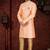 Peach sherwani with gold trim, ornate buttons, and matching pocket square.