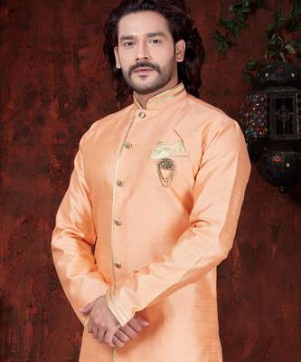 Peach sherwani with gold trim, ornate buttons, and matching pocket square. 2
