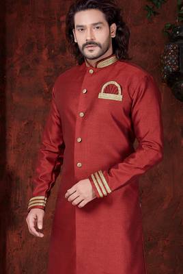 Maroon sherwani with gold trim, ornate buttons, and embroidered pocket square. 2