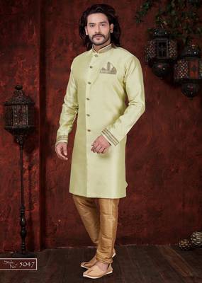 Light pistachio sherwani with gold-trimmed cuffs and collar, ornate buttons,& pocket square. 1