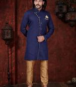 Navy-blue sherwani with asymmetrical placket, gold pocket square, and gold trousers.