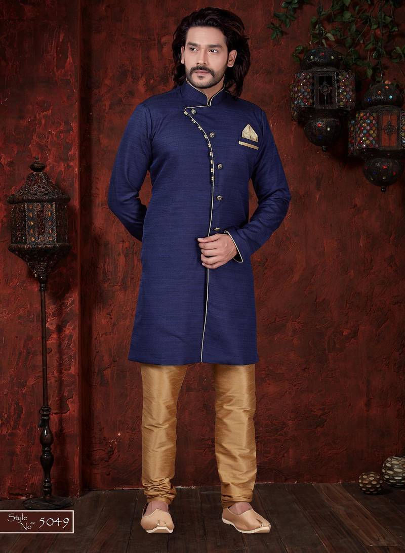 Navy-blue sherwani with asymmetrical placket, gold pocket square, and gold trousers.