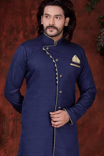 Navy-blue sherwani with asymmetrical placket, gold pocket square, and gold trousers.