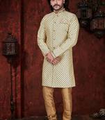 Fawn sherwani with gold motifs, matching pocket square, and gold trousers—ideal for weddings.