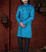 Turquoise sherwani with textured finish, black accents, and black trousers.