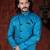 Turquoise sherwani with textured finish, black accents, and black trousers.