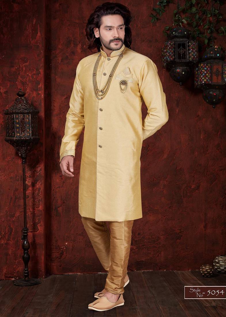 Golden-beige sherwani with stand collar, pearl necklace, and embellished pocket square.