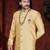 Golden-beige sherwani with stand collar, pearl necklace, and embellished pocket square.
