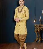 Mustard floral sherwani with pearl accessories, embellished pocket, and gold trousers.