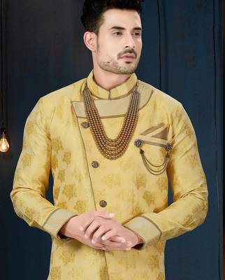 Mustard floral sherwani with pearl accessories, embellished pocket, and gold trousers. 2