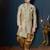 Blue-and-gold patterned sherwani with ornate buttons, burgundy pocket,with gold trousers.