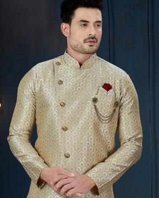 Blue-and-gold patterned sherwani with ornate buttons, burgundy pocket,with gold trousers. 2