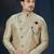 Blue-and-gold patterned sherwani with ornate buttons, burgundy pocket,with gold trousers.