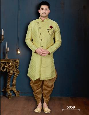 Light-yellow patterned sherwani with ornate buttons, burgundy pocket, and gold trousers. 1