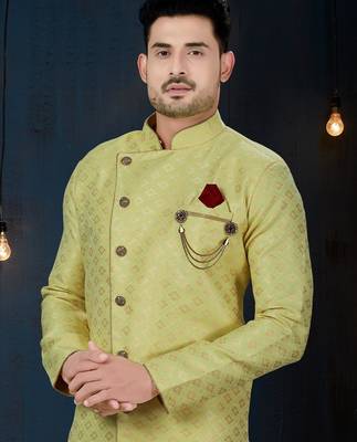 Light-yellow patterned sherwani with ornate buttons, burgundy pocket, and gold trousers. 2