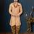 Peach patterned sherwani with pearl accessories, burgundy pocket, and gold trousers.