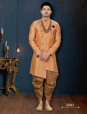 Peach jacquard sherwani with pearl accessories, burgundy pocket, and gold trousers. 1