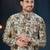 Cream floral sherwani with blue motifs, gold buttons, and gold trousers.