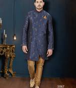Navy-blue sherwani with floral motifs, gold detailing, and matching pocket square.