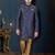 Navy-blue sherwani with floral motifs, gold detailing, and matching pocket square.