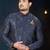 Navy-blue sherwani with floral motifs, gold detailing, and matching pocket square.