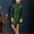 Emerald-green sherwani with floral motifs, gold pocket square, and gold trousers.