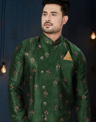 Emerald-green sherwani with floral motifs, gold pocket square, and gold trousers. 2