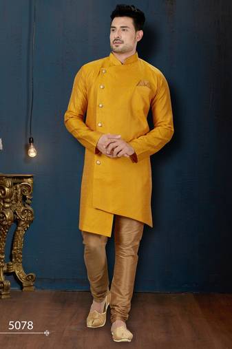 Mustard-yellow sherwani with jacquard texture, asymmetrical front, and matching pocket square.
