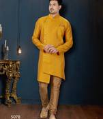 Mustard-yellow sherwani with jacquard texture, asymmetrical front, and matching pocket square.