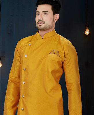 Mustard-yellow sherwani with jacquard texture, asymmetrical front, and matching pocket square. 2