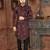 Burgundy floral sherwani with black patterns, chain pocket detail, and black trousers.