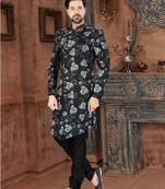Black floral sherwani with grey blooms, chain pocket detail, and black trousers.