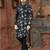 Black floral sherwani with grey blooms, chain pocket detail, and black trousers.