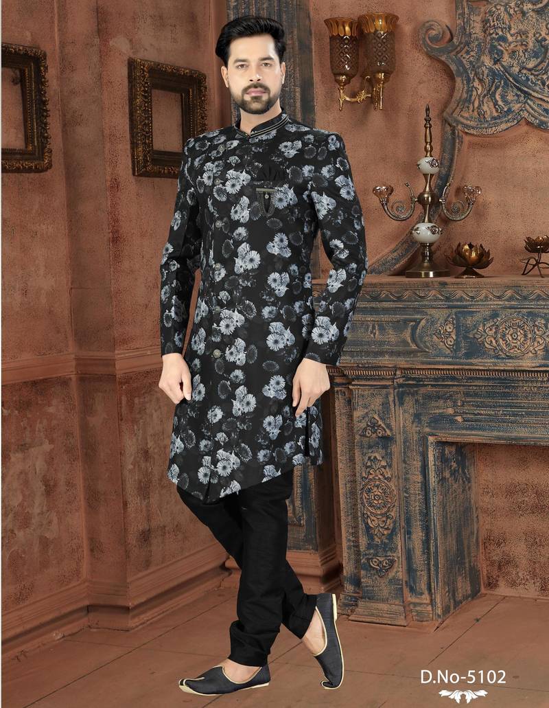 Black floral sherwani with grey blooms, chain pocket detail, and black trousers.