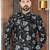 Black floral sherwani with grey blooms, chain pocket detail, and black trousers.