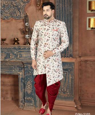 Off white floral sherwani with coral pocket accent and red trousers. 1