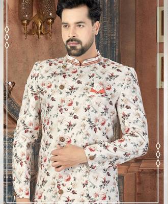 Off white floral sherwani with coral pocket accent and red trousers. 2