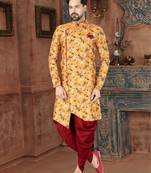 Mustard floral sherwani with burgundy pocket square and matching trousers.