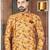Mustard floral sherwani with burgundy pocket square and matching trousers.