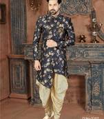 Navy floral sherwani with embellished pocket and ivory dhoti-style trousers.