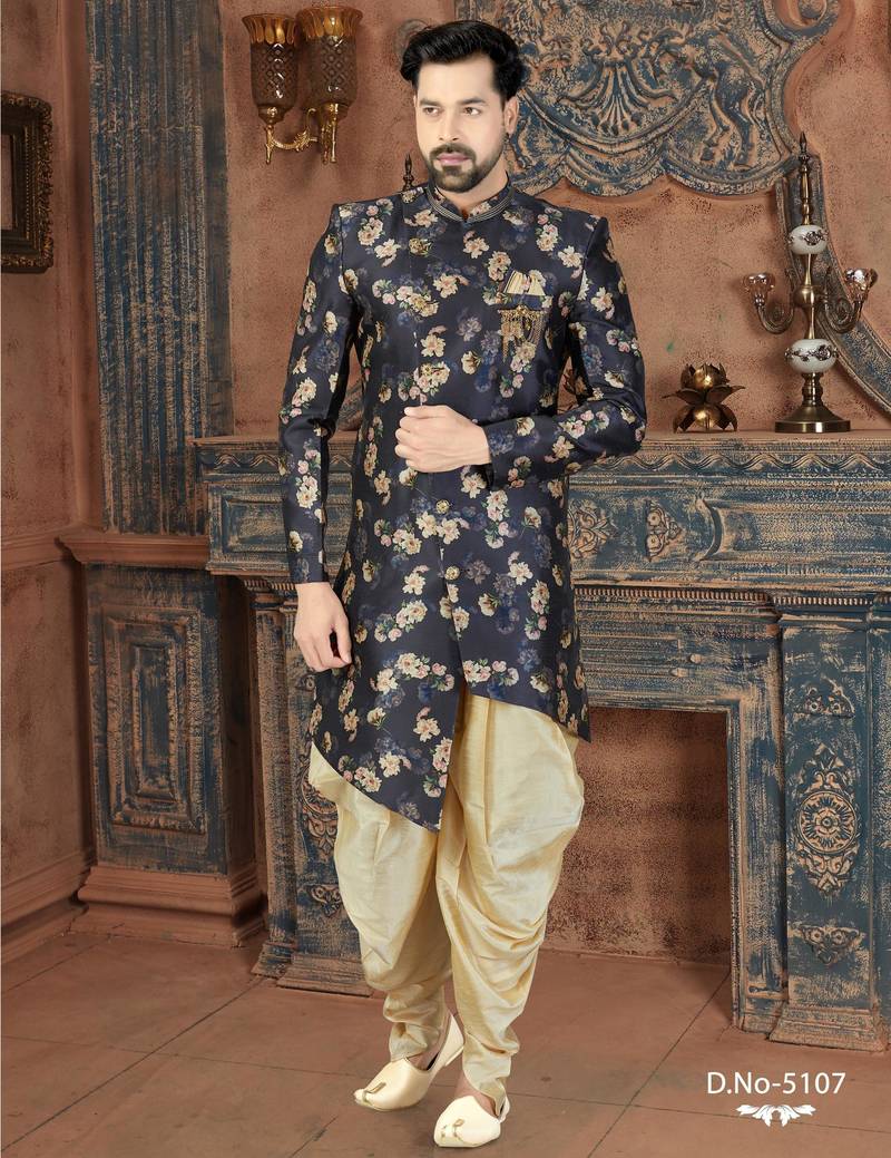Navy floral sherwani with embellished pocket and ivory dhoti-style trousers.