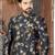 Navy floral sherwani with embellished pocket and ivory dhoti-style trousers.