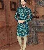 Teal floral sherwani with matching pocket square and ivory trousers.