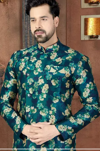 Teal floral sherwani with matching pocket square and ivory trousers.